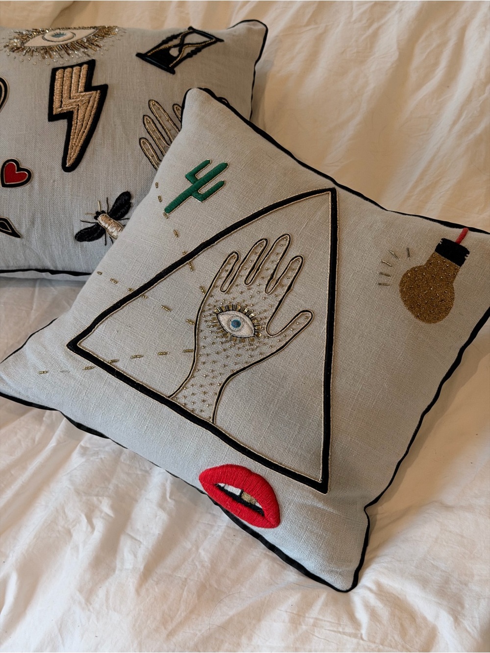 Two Jonathan Adler embroidered/appliqué linen pillows
